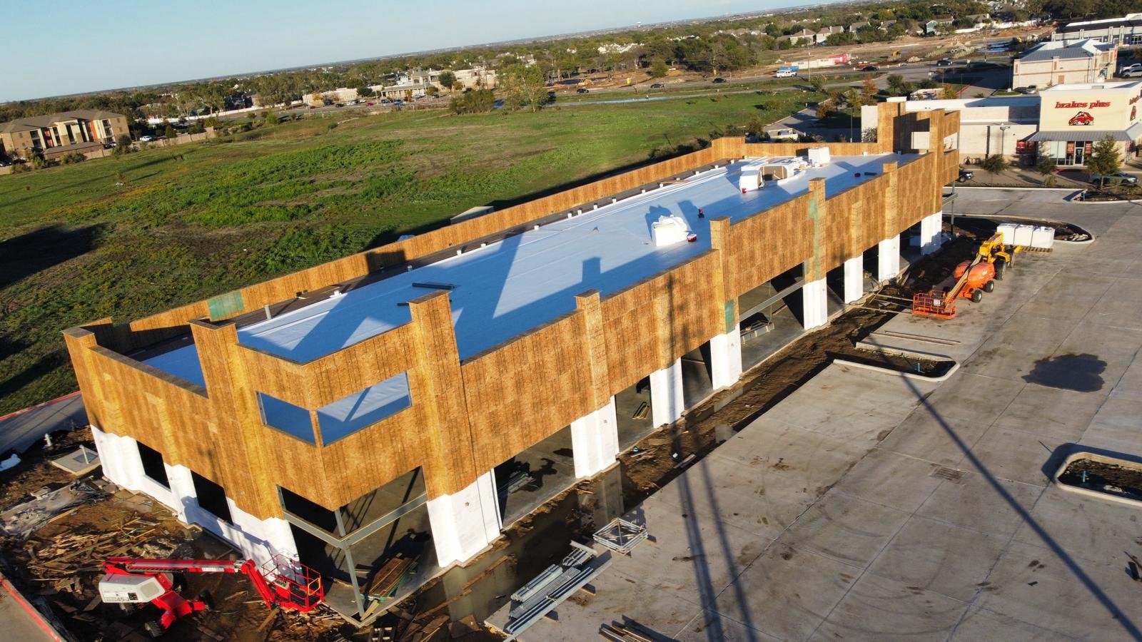 Azure Plaza Project Update: Tyvek Installation and Roofing Progress in Little Elm by Jabes Constructors INC and EM Building Contractors LLC